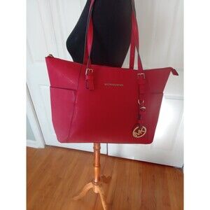 Michael Kors JetSet Travel tote in vibrant red.   Never used but without tags.